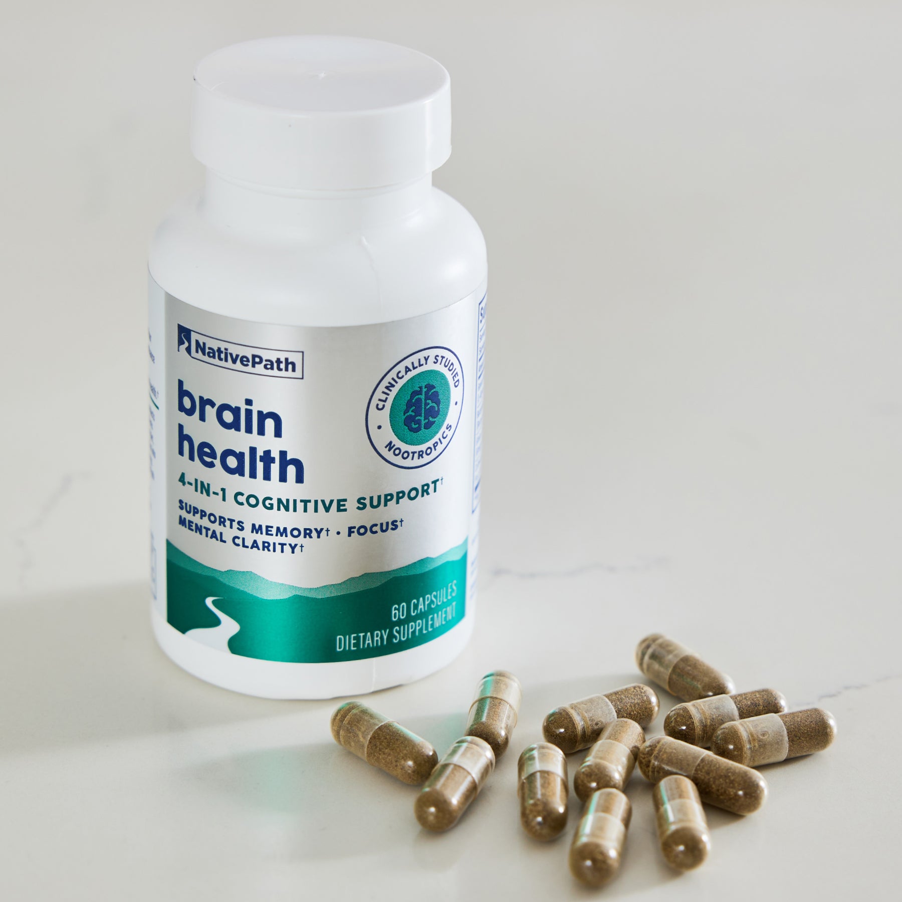 NativePath Brain Health bottle on a countertop surrounded by loose capsules